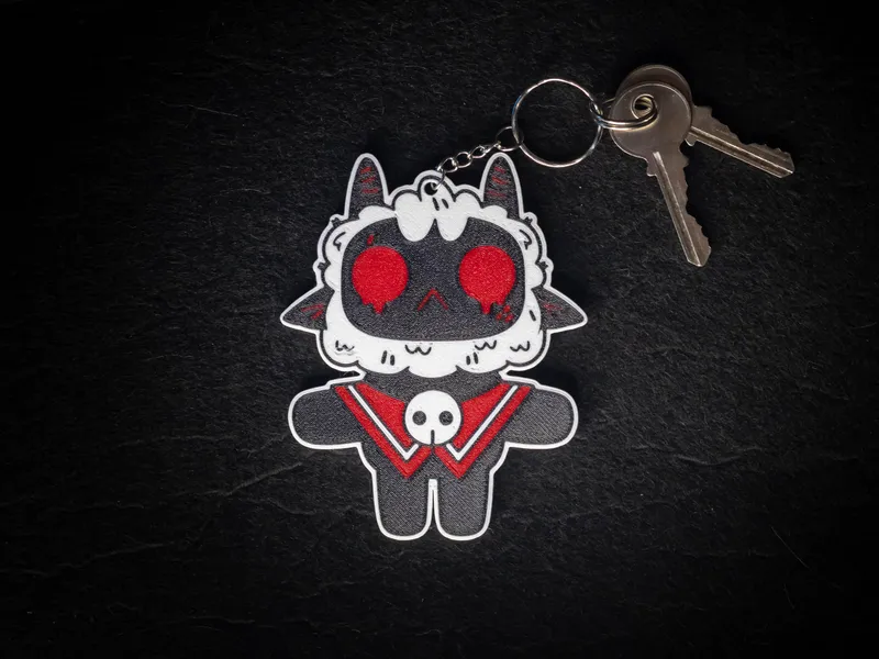 3D-printed Cult of the Lamb keychain: the Lamb with red eyes and a skull collar, on a metal key ring