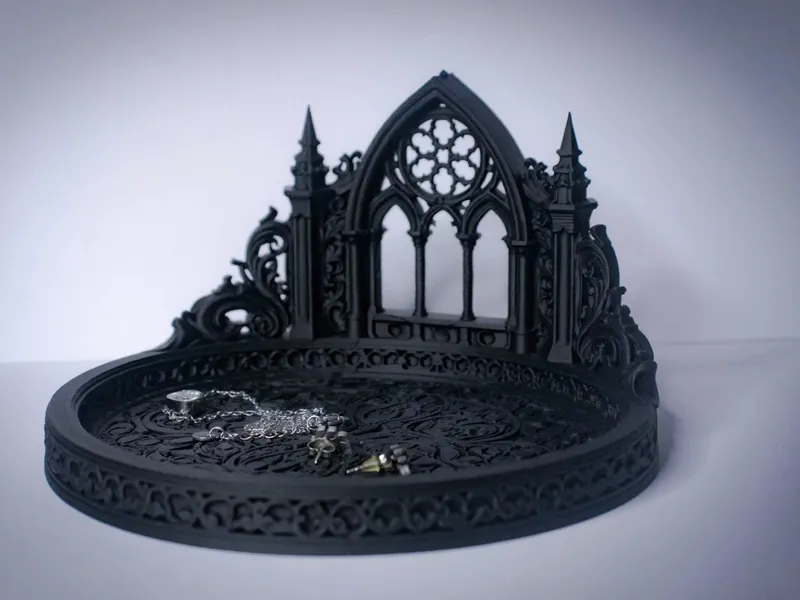Black 3D-printed gothic cathedral jewelry stand with a rose-window arch, spires and a filigree tray holding silver jewelry